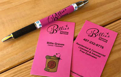 Hot pink business cards and pen with Billie's Cleaning Services Logo